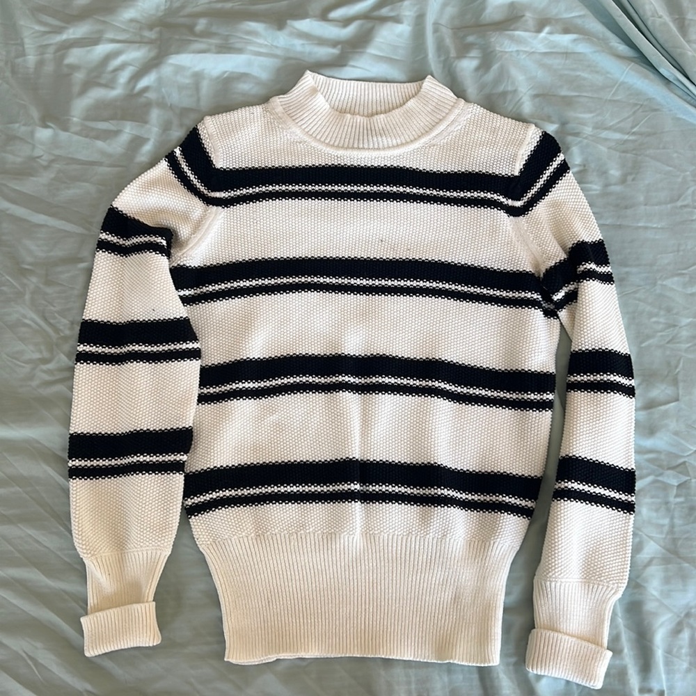 Cream colored sweater with black stripes. Size small.